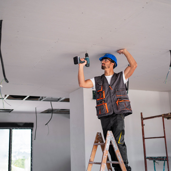 Man and woman standing on ladder